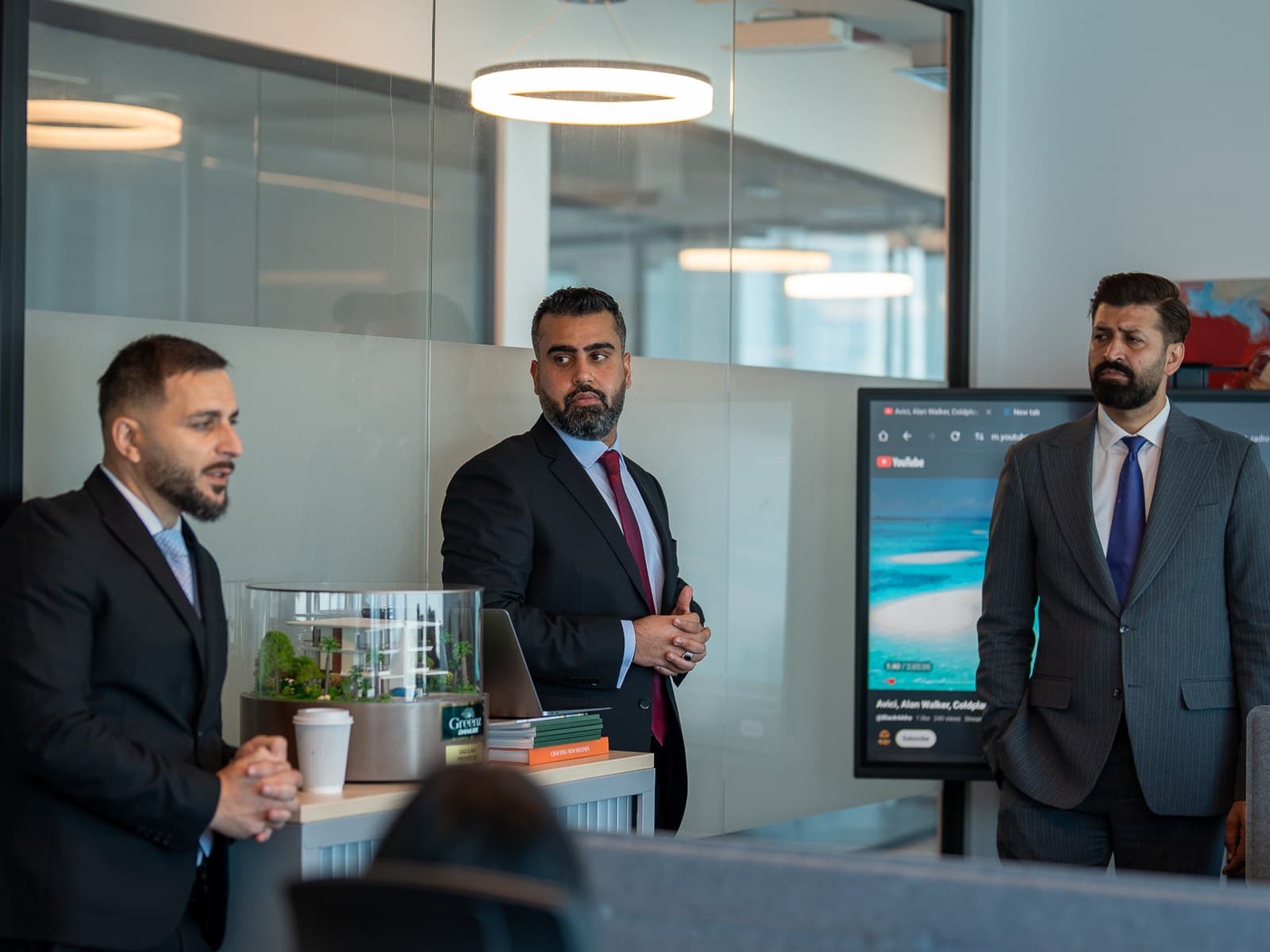 Three colleagues talking in a meeting room